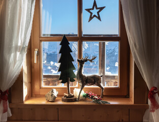 Window in a mountain hut overlooking a mountain range, decorated for Christmas, Austria, Salzburg