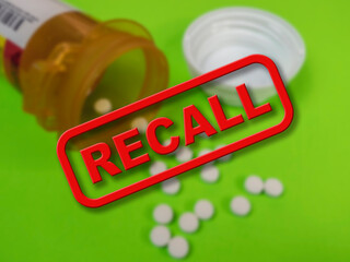 Blurred background of prescription medicine with the word Recall in the foreground