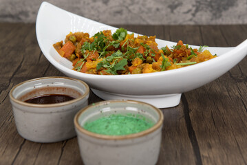 Traditional Indian meal consisting of a bowl of mixed vegetables and humus dipping sauce for extra...