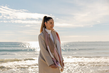 Portrait of a young pretty girl on the background of the sea