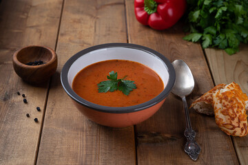 Roasted Red Pepper Soup with bread. Roasted Red Pepper Soup on wood background