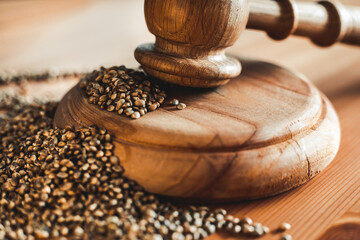 Legality of Medical Cannabis and Seeds, legal and illegal Cannabis, Seeds on the World - Wooden judge hammer and sound block with seeds and flower of marijuana CBD on the pinewood table background.