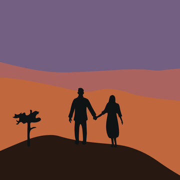 Silhouette of a couple walking in the desert