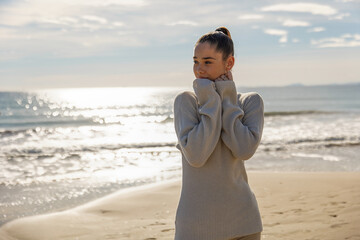 Portrait of a young pretty girl on the background of the sea