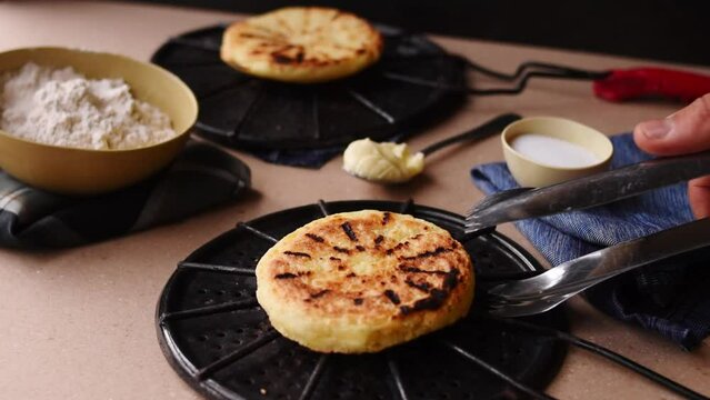 Hand taking an "Arepa" Clombian traditional food
