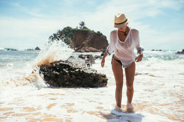a beautiful girl washes away with a wave