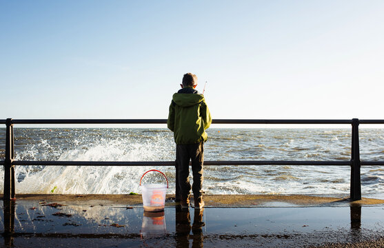 young boy fishing for crabs on a beautiful winter day