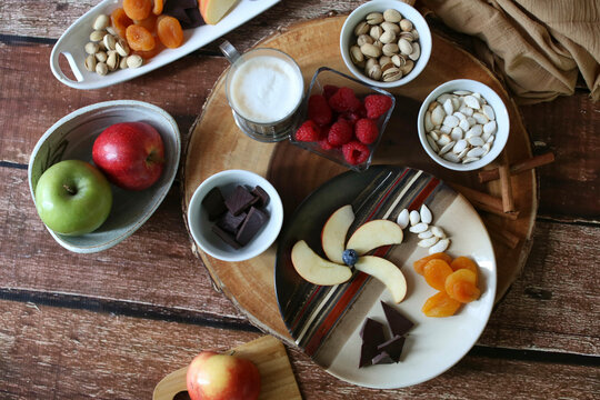 layflat shot of fruit and nut charcuterie board brown background