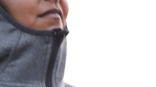 Fitness, exercise clothes and zip on jacket of woman outdoor for running, workout and cardio training in grey fabric for winter. Face of female staying warm, comfortable and ready to run in India
