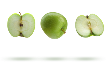 Whole and halved apple in the air on a transparent background.