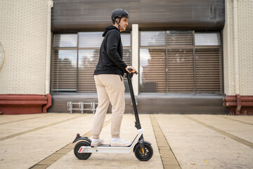 caucasian man drive or ride electric kick scooter e-scooter