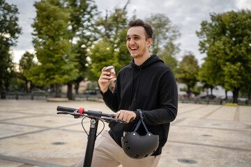 caucasian man drive or ride electric kick scooter e-scooter