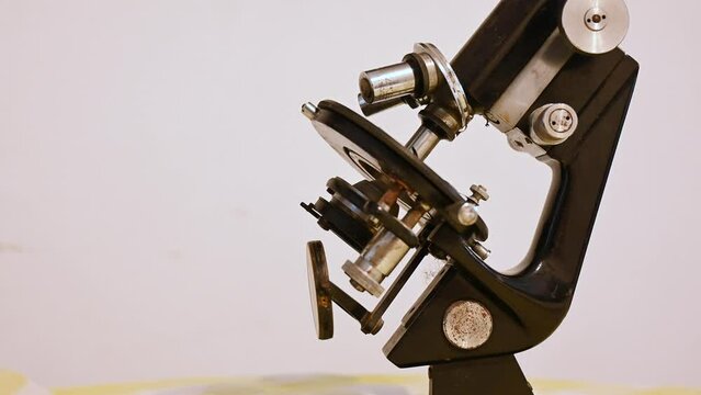 An old microscope, close up. Vintage microscope on the table.