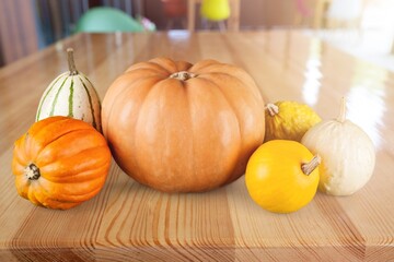 Fresh ripe autumn pumpkins on desk