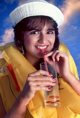 Fototapeta premium model having fun with sailor cap and glass with water and red fish