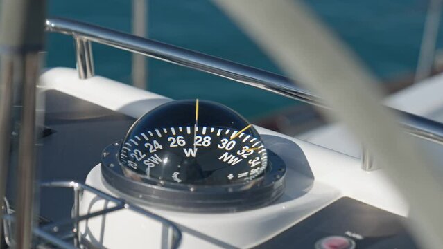 Rounded external nautical compass on yacht. Handheld shot and close-up