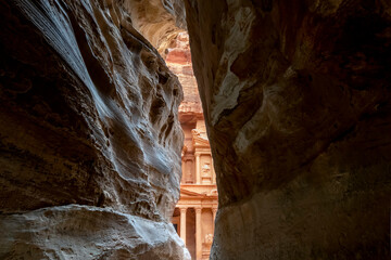 The ancient Treasury Building or Al Jhazneh, seen from the Siq, a narrow gorge through the sandstone canyon in Petra, Jordan.