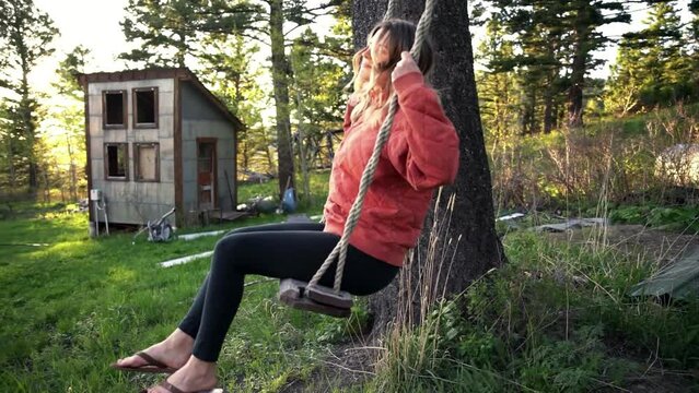 Country girl going gaga on a swing at Red Lodge Montana woods