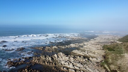 Rocky beach with crashing waves. 