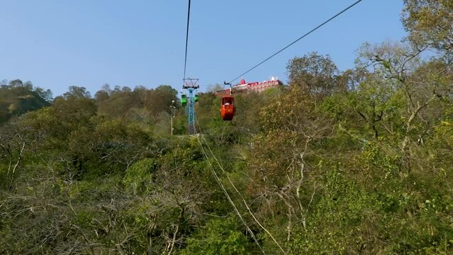 rope way running through green forests to mountain top video is taken at Mansa Devi Temple rope way haridwar uttrakhand india on Mar 15 2022.
