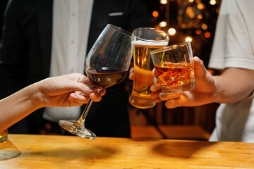 food and drink male friends are happy drinking beer and clinking glasses at a bar or pub.