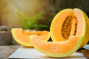 Naklejka na ściany i meble sliced of melons, fresh Melon or cantaloupe, Cantaloupe melons on wood background, Favorite fruit in summer