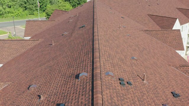 Aerial, residential rooftop with brown red shingle tiles