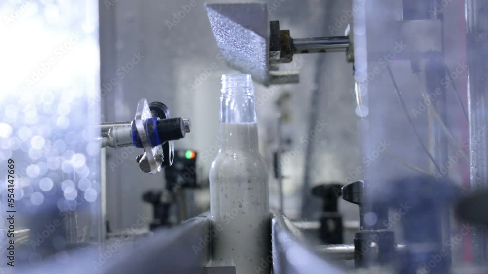 Poster 4k close up of automated sauce bottle filling machine in factory process line