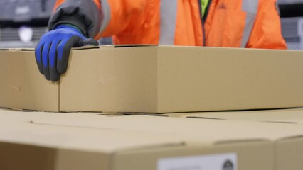 4K Close Up Of Warehouse Worker Stacking Cardboard Boxes By Hand