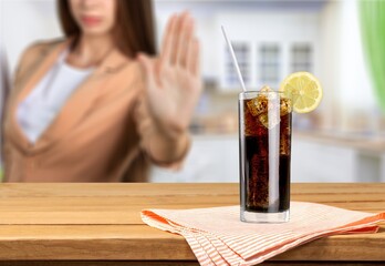 Young woman make stop sign showing on junk drink