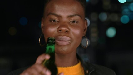 Night, party or face of a black woman with beer drinking alcohol at a rooftop event in a city in celebration of New Year. Portrait, smile or happy African girl laughing with drinks to celebrate life