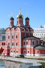 Fototapeta na wymiar Red stone church with five domes.