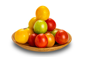 Side view pile of colorful freshly harvested organic cherry tomatoes in wooden plate isolated on white background with clipping path.