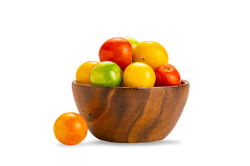 Group of colorful freshly harvested organic cherry tomatoes in wooden bowl isolated on white background with clipping path.