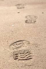 Fototapeta na wymiar Footprint sand marks walking true foot marks 