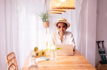 Happy asian man working with laptop at home,Work from home