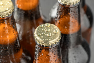 Cold beer in a brown bottle with large water drops on the glass surface. Dark craft beer