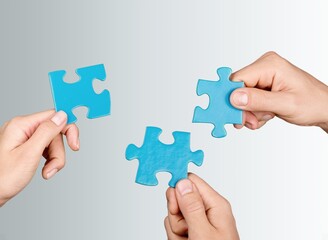 Business persons hands holding puzzle pieces