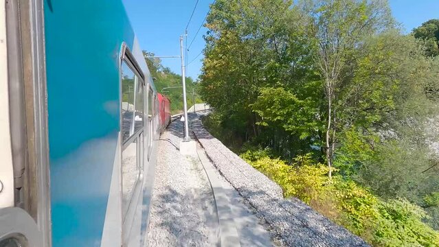 Passenger train in Slovenia leaving Ljubljana by a river, onboard camera