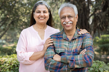 Happy senior couple spending leisure time in park during weekend.