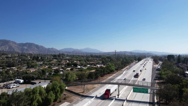 Aerial View of Traffic on American Interstate Highway 210 by Residential Neighborhood of Los Angeles USA