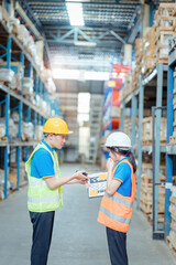 Warehouse worker being scolded and admonished by the supervisor ,Warehouse worker checking packages on shelf in a large store.