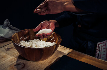 Japanese chef making rice nigiri sushi with tuna, salmon, shrimp,traditional Japanese food ,Dark Tone