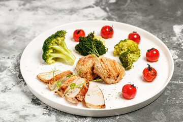 Grilled Turkey breast meat and broccoli on a white plate. Delicious and healthy food. KETO diet concept