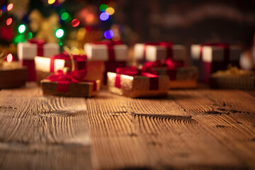 Naklejka na ściany i meble Christmas background. Shallow depth of focus. Colorful bokeh lights, rustic wooden table. Place for typography. 
