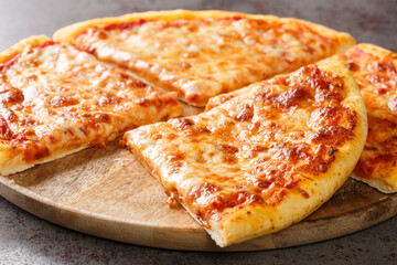 New York style pizza with toppings are simply tomato sauce and melted mozzarella cheese closeup on...