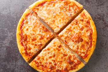 Freshly baked New York style pizza with melted mozzarella cheese and base tomato sauce close-up on...