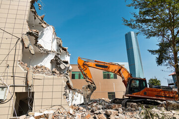 Construction machinery is demolishing the house