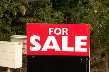 For sale sign on black board near the resedential building. Property Real estate concept