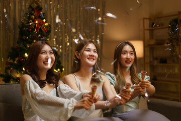 New Year party concept, Young beautiful group shooting confetti poppers with having fun in party